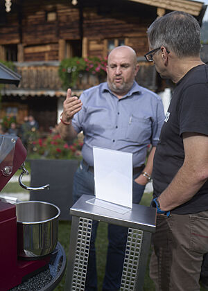 Richard Häußler steht mit einem Mann neben einer Teigknetmaschine.