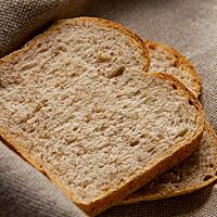 Zwei Scheiben des Toastbrotes mit Roggenschrot zeigen die fluffige, weiche Krume.