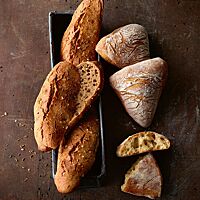 Sowohl die länglich geformten Dinkelseelen (links) als auch die dreieckigen Dreikornbrötchen (rechts) haben eine lockere, mittelporige Krume.