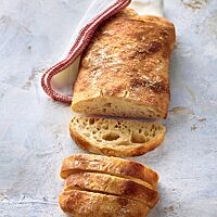 Das Ciabatta hat eine glatte, goldgelb bis goldgelb ausgebackene Oberfläche und eine helle, mittel- bis grobporige Krume.